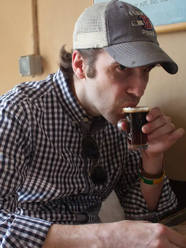 JLCC customer sipping coffee